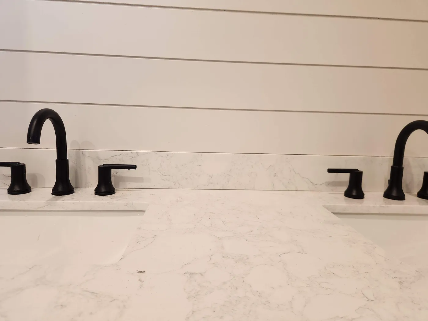 New black faucets on a bathroom vanity