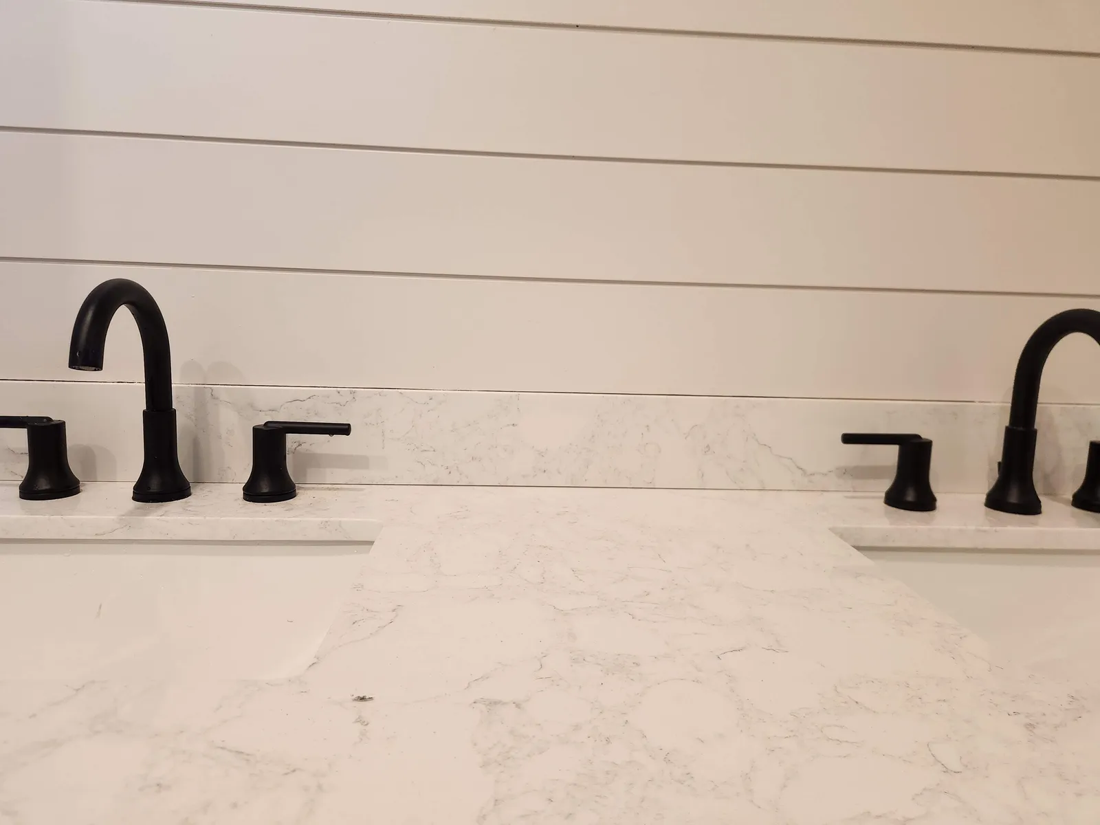 New black faucets on a bathroom vanity