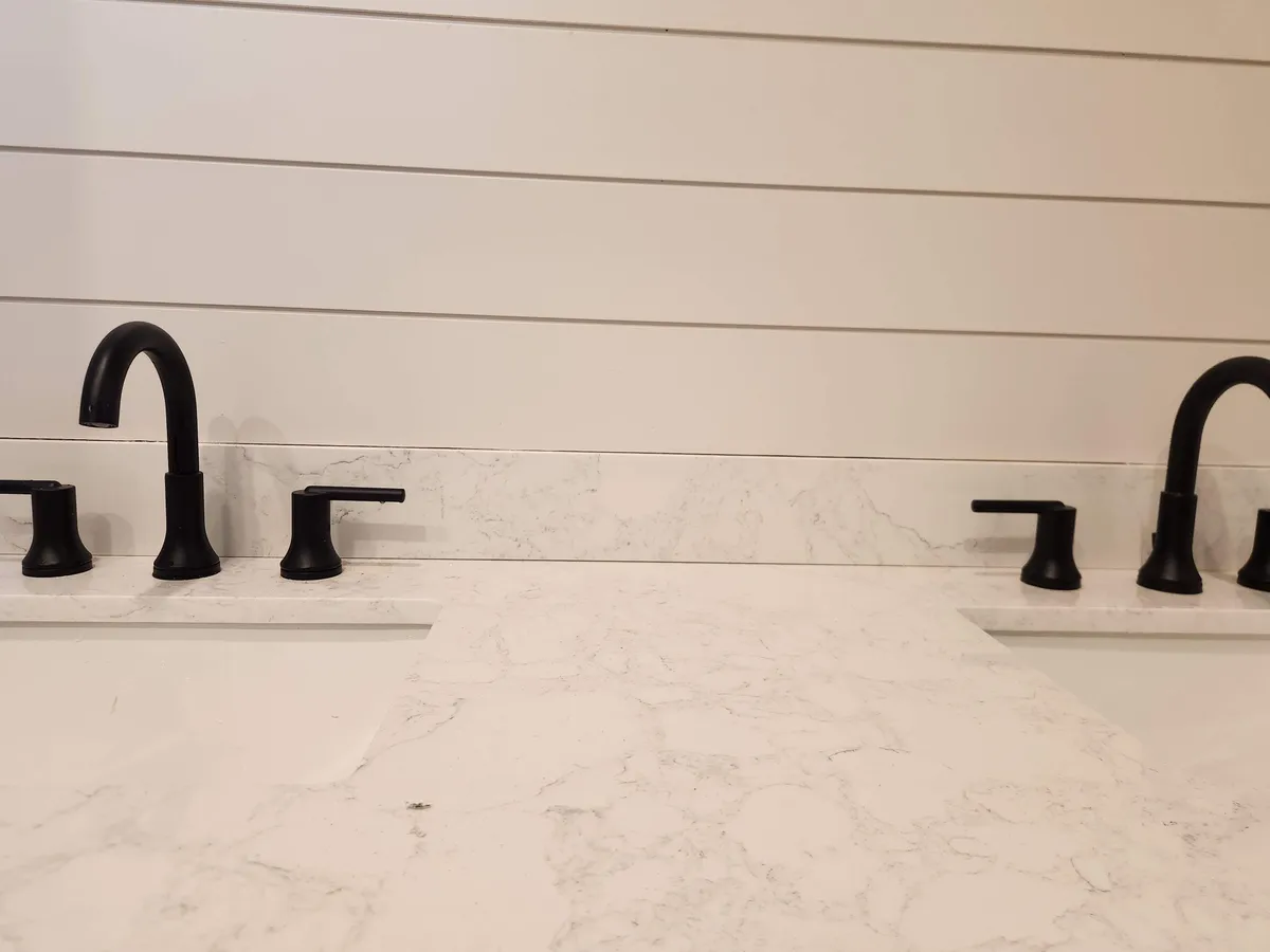 New black faucets on a bathroom vanity