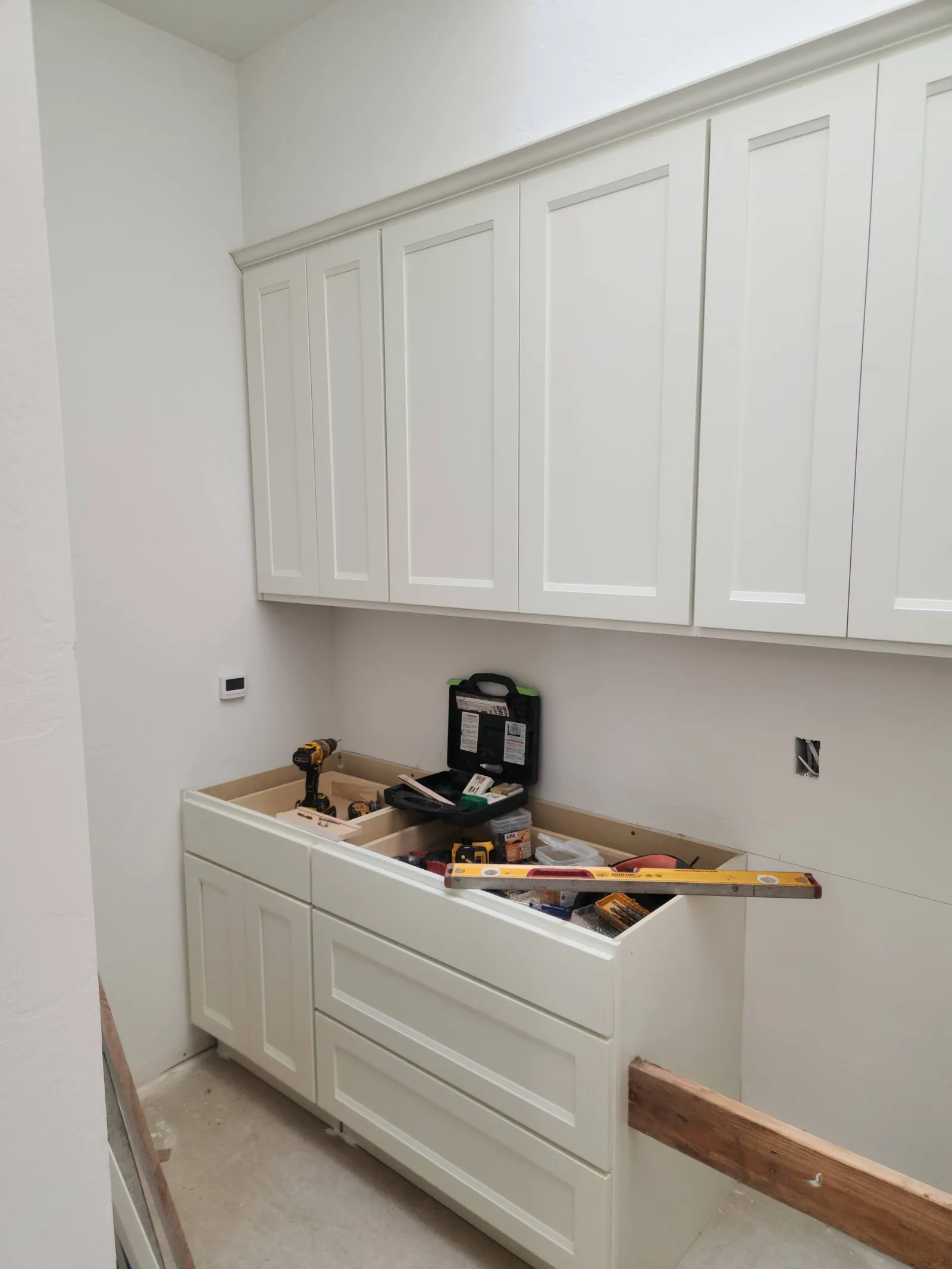 White shaker cabinets mid-install