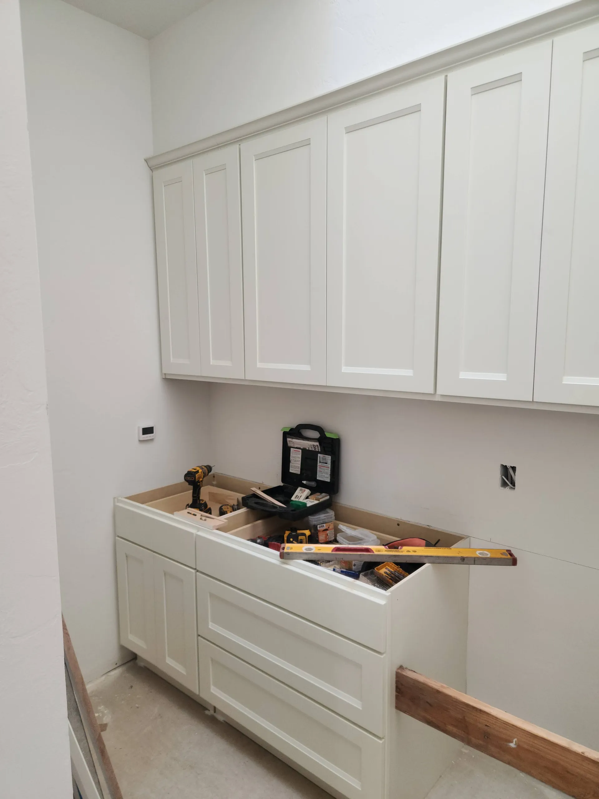 White shaker cabinets mid-install