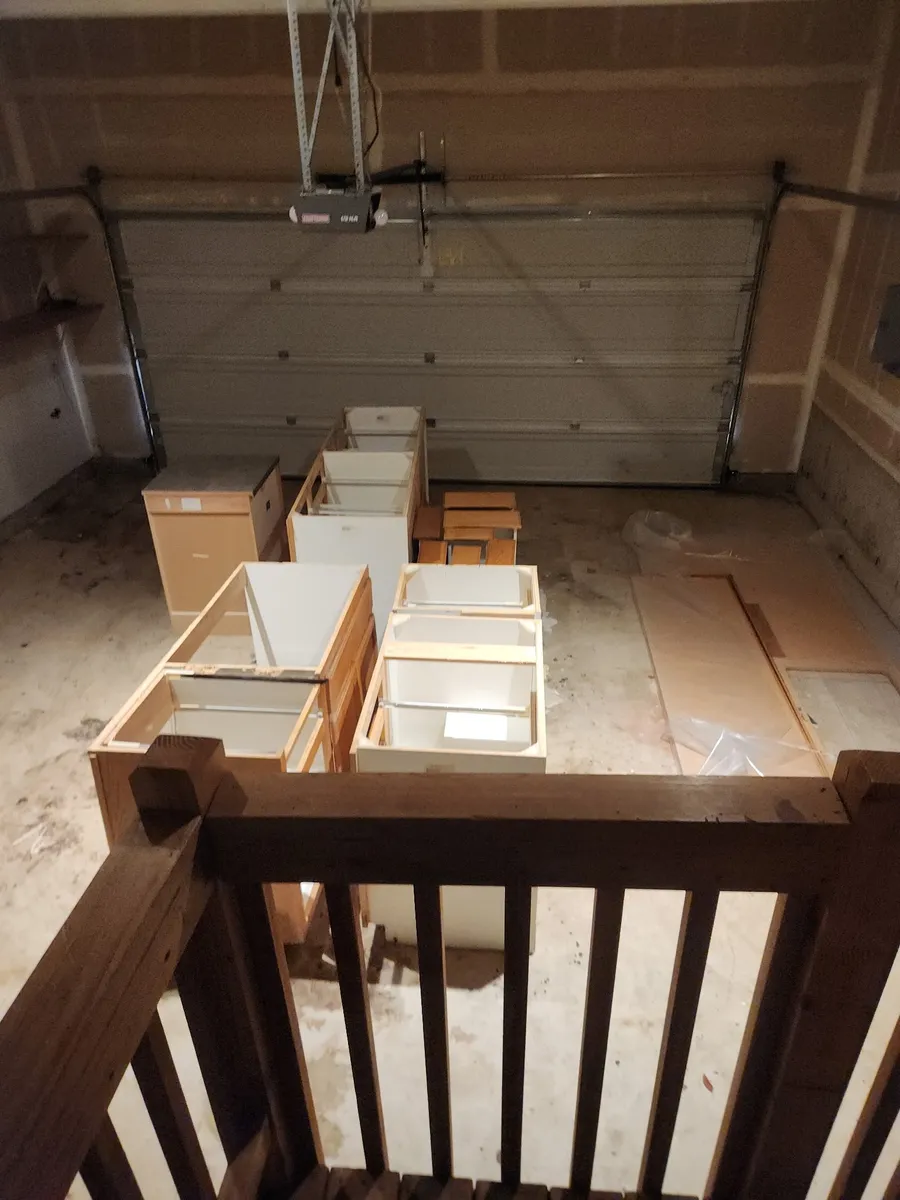 Cabinet boxes unpacked and staged in a garage before installation