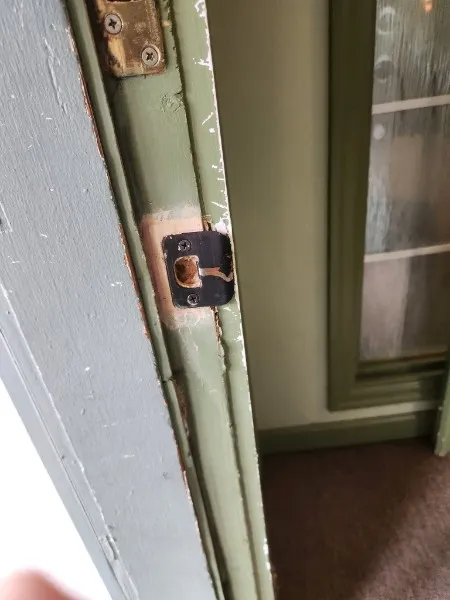 Strike plate in a repaired door jamb