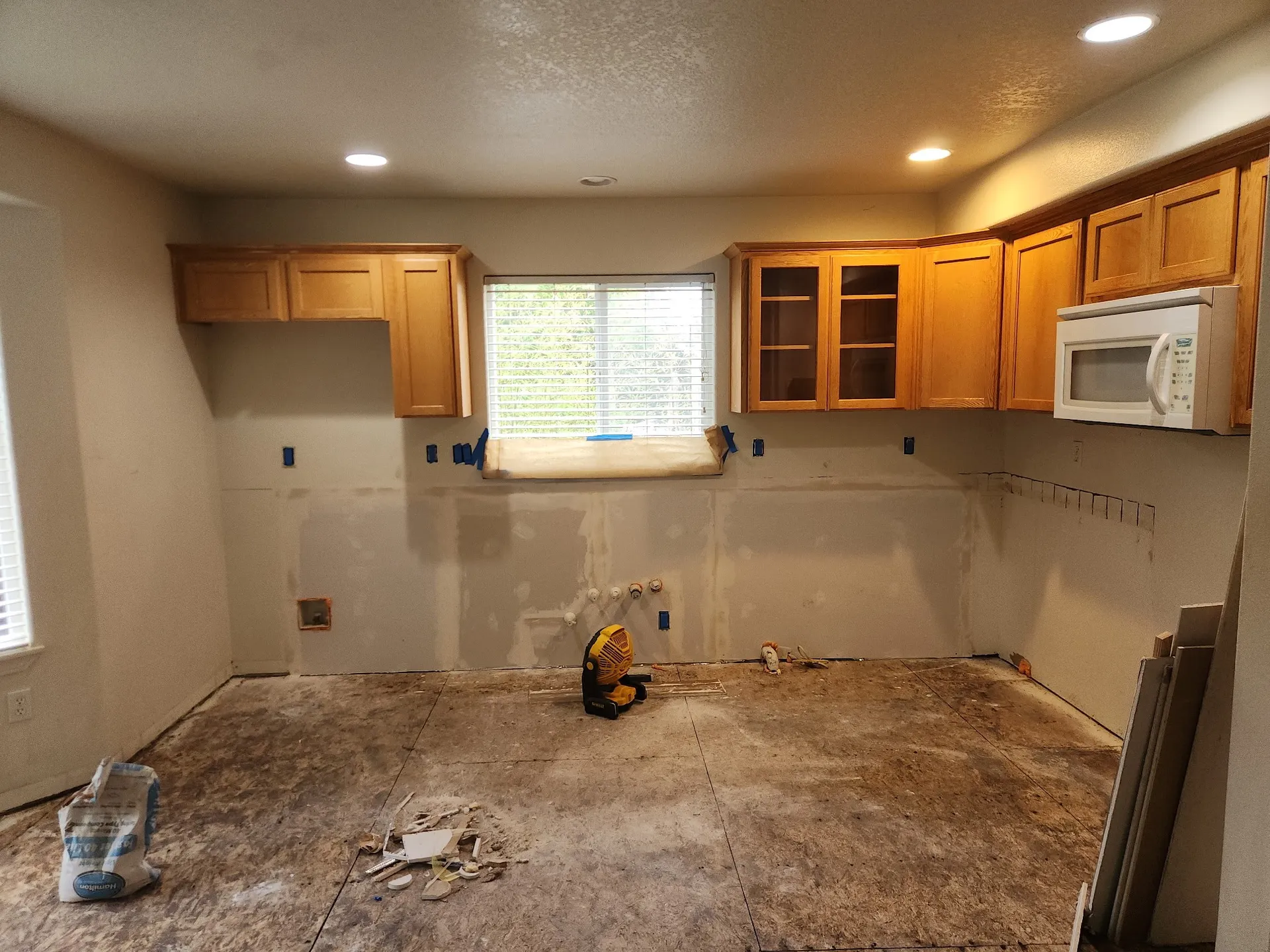 Kitchen wall with new drywall taped and mudded