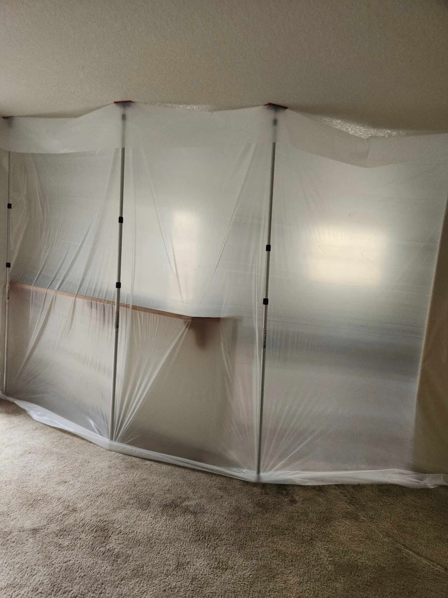 Plastic dust containment walls set up around a work area