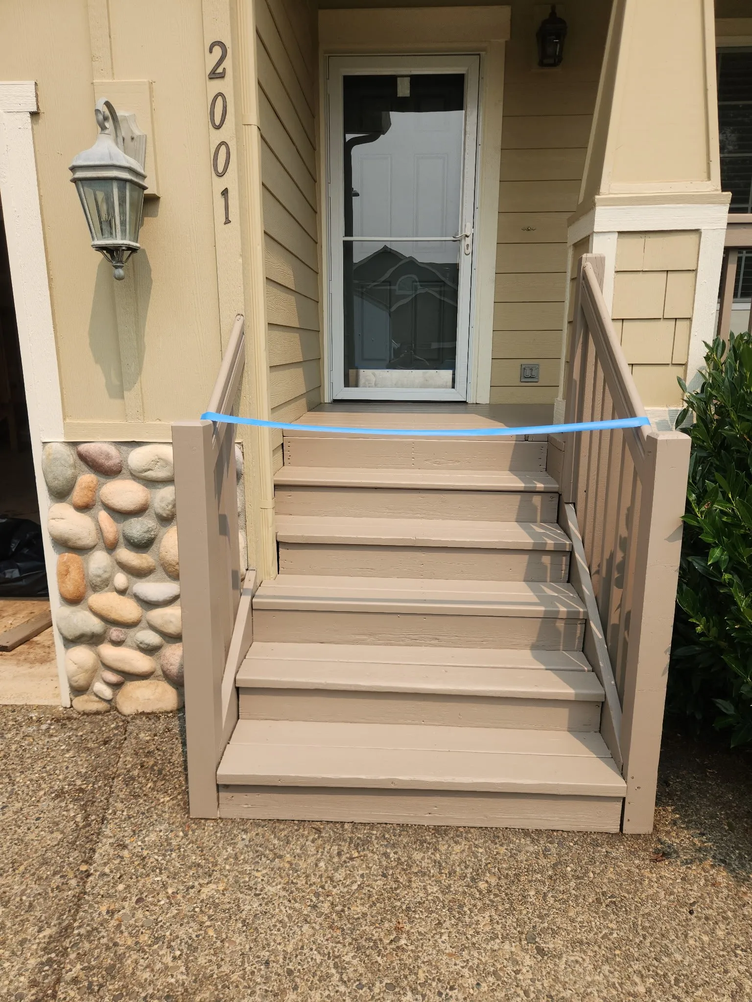 Painted front steps taped off while the paint dries