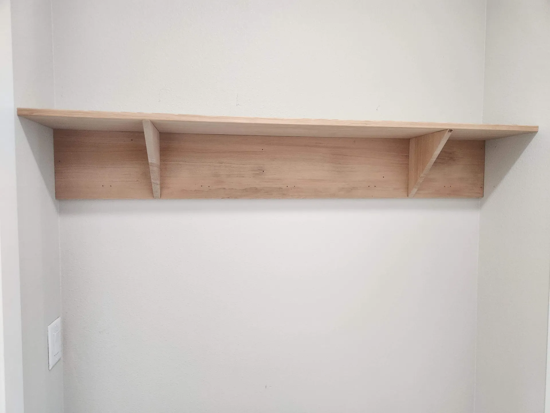 Wood wall shelf on brackets