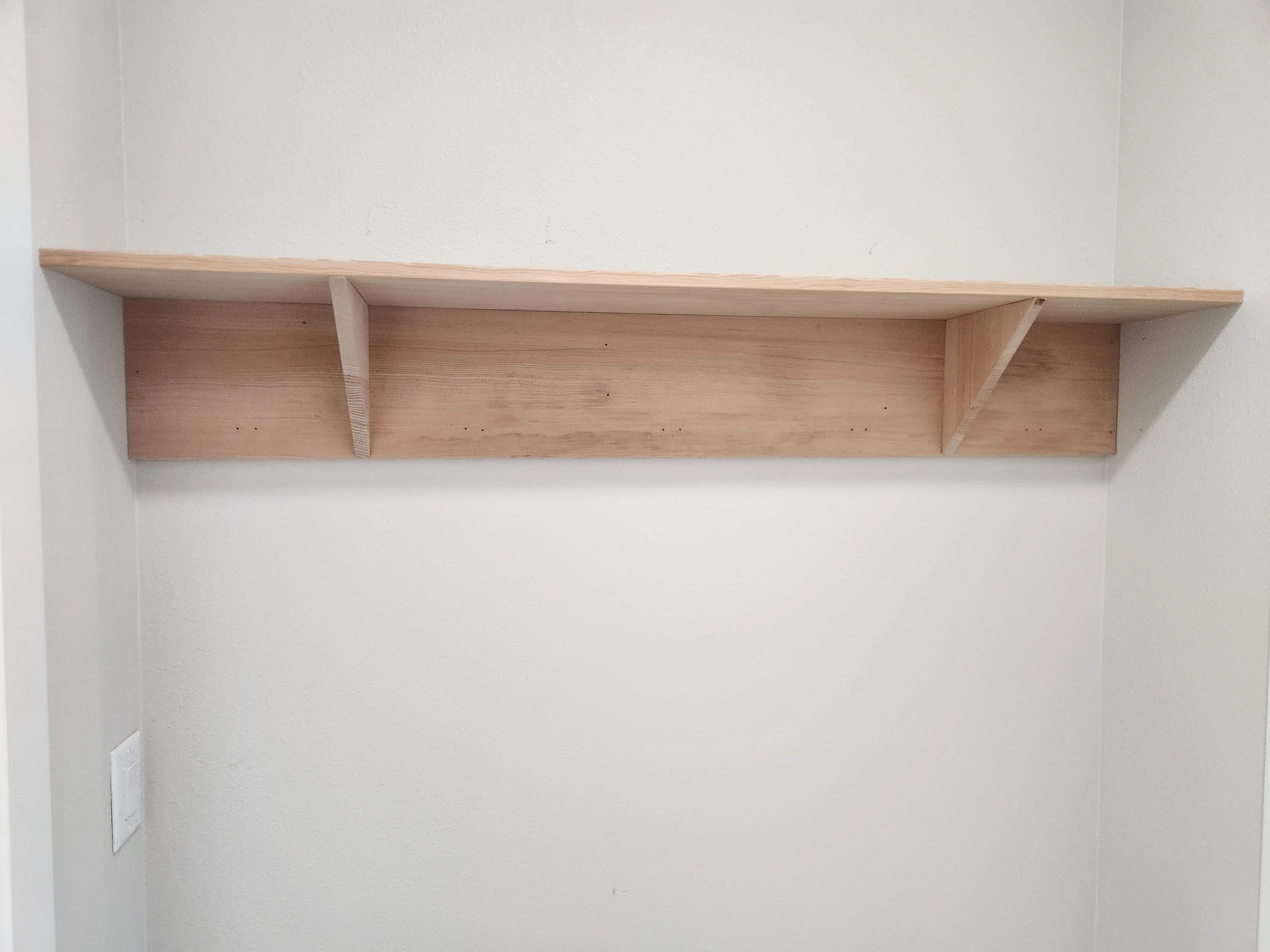 Wood wall shelf installed above a counter