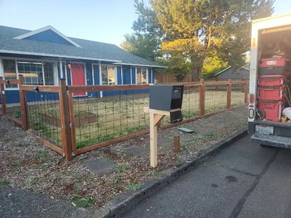 Finished cedar mailbox post beside the curb